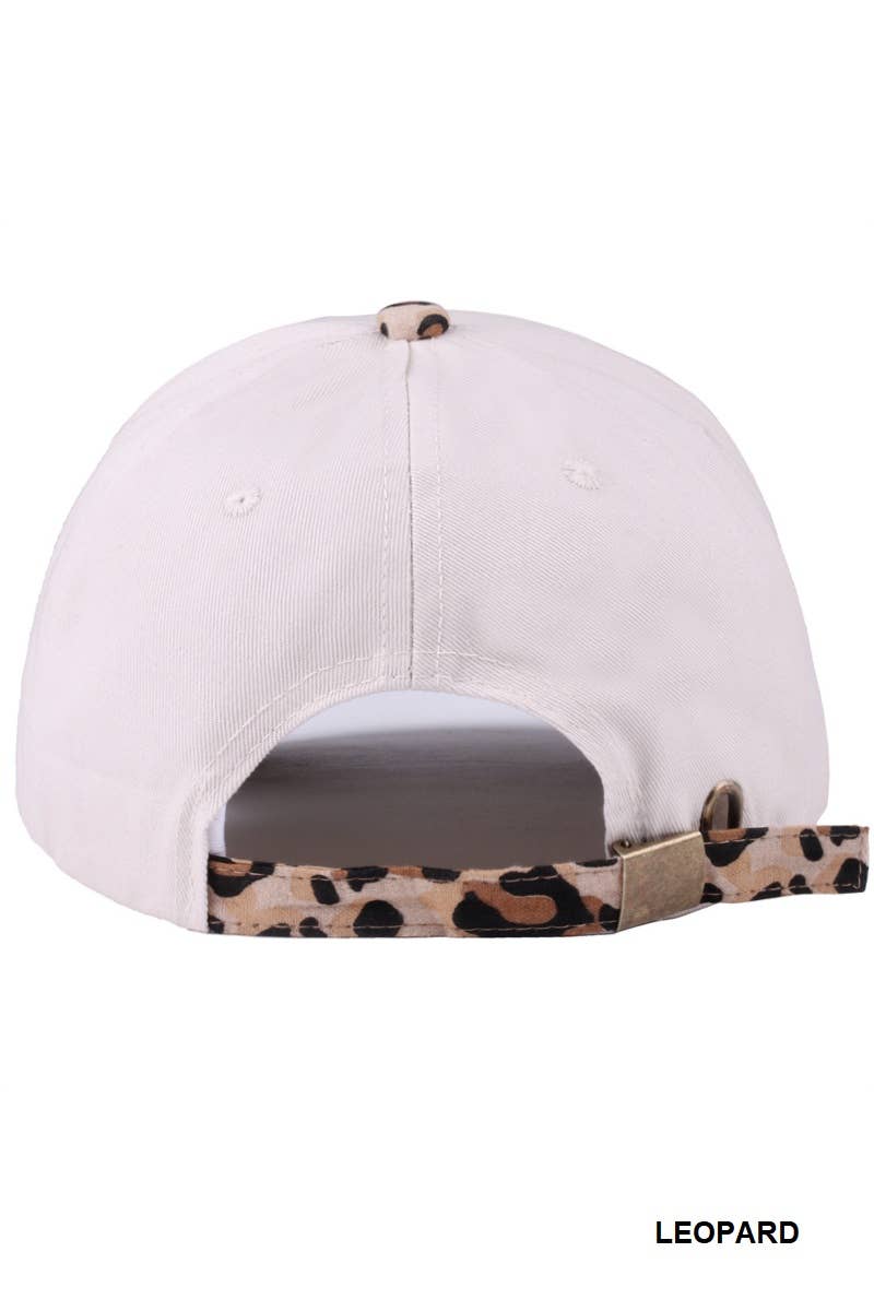 White cap with a leopard print brim on a white background
