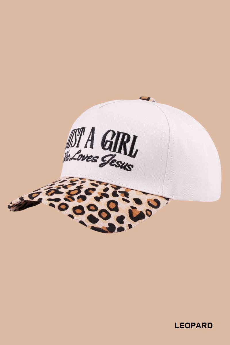 White cap with leopard print bill and 'Just a Girl Who Loves Jesus' text on a beige background