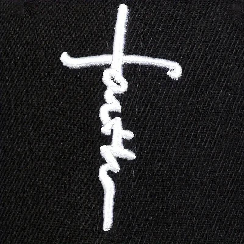 White embroidered cross design on a black fabric background